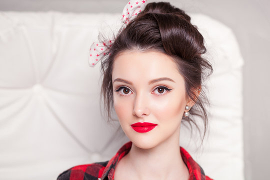 beautiful young woman on white background in old fashion clothes representing pinup and retro style