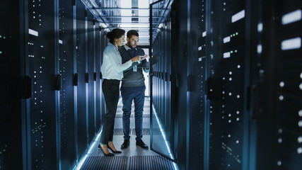 Woman and man working in server room
