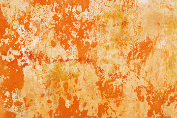 Light gray cement wall with yellow orange red crack peeling paint. Grunge vintage abstract background.