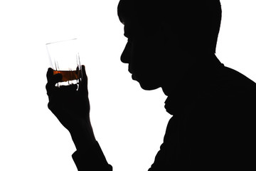 Silhouette of a man with a glass of alcoholic drink