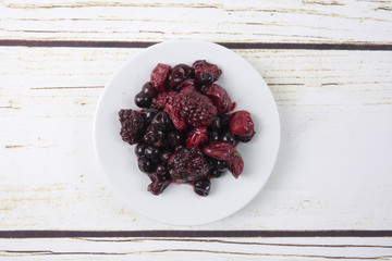 Strawberry,bluberry and cherry pickles on wooden background.