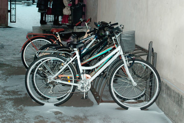 Bikes in the snow on campus.