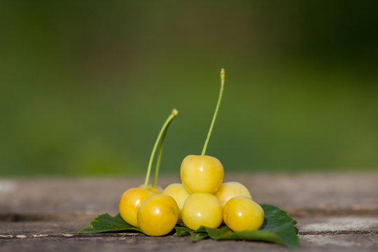 Yellow cherries on a wooden table