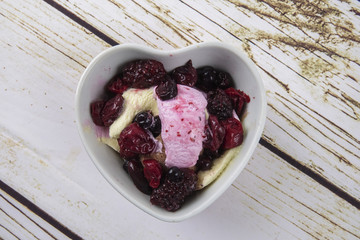 Ice cream scoops with blueberry,chery on wooden table.
