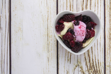 Ice cream scoops with blueberry,chery on wooden table.