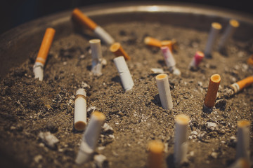 Cigarette butts on sand.