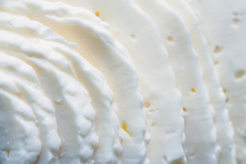 Closeup slices of brined cheese
