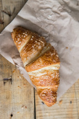 Fresh croissant lies on paper