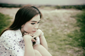 Fototapeta premium Lonely Sad fat woman ,She think over from love,heartbreak,Heartbroken because of disappointment,Thailand people