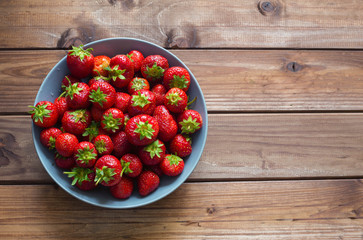 Strawberries on the wooden table / Place for a text
