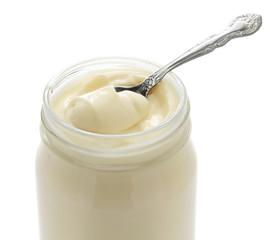 opened mayonnaise jar and spoon isolated on white background