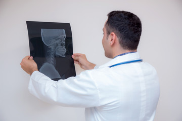 healthcare with roentgen - people and medicine concept - male doctor in white coat looking at x-ray isolated on white background