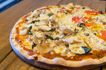 Italian pizza / close up vegetarian Italian pizza with mushroom and tuna on wooden table, Selective focus.