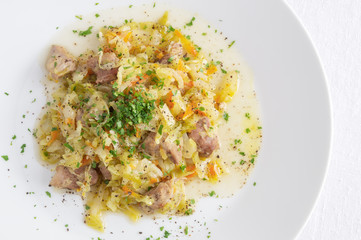 white cabbage stew with pork, carrot, onion, garlic, and herbs