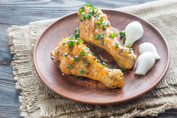 Portion of baked chicken drumsticks