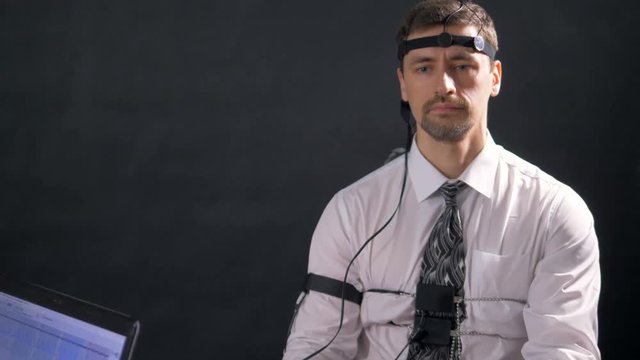 Polygraph screen and a test subject answering questions. 4K 60 fps.