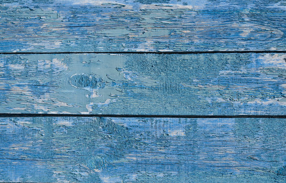 Abstract background texture of natural wood vertical boards, painted bright blue paint with natural patterns