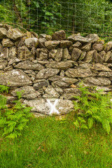 Cross on wall marking where wheel was found after explosion