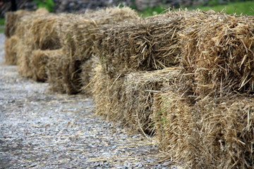 Hay bale wall along gravel country path