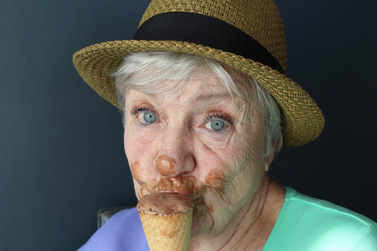 Happy senior woman eating ice cream