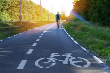 The bike path goes into the distance. A sign of a bicycle. Place for the inscription