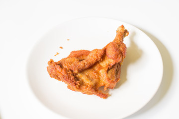 crispy  fried chicken in  the white dish on a wooden table , close up delicious fried chicken , close up