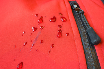 large drops of water on waterproof clothes. zippers pocket fastener