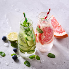 Infused detox water, healthy refreshing drink with lime, grapefruit, berries and mint, square
