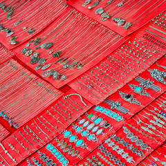Necklaces and bracelets on counter of a small shop. Laos