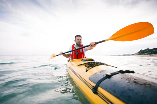 Man paddling sea kayak