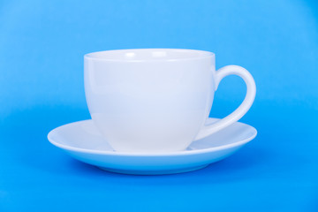A white cup on blue background