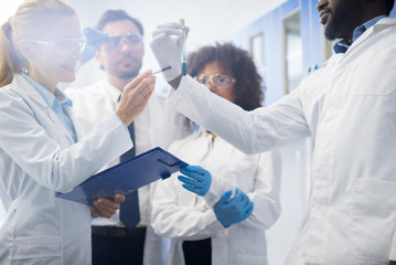 Scientists Team Working In Laboratory Doing Research, Man And Woman Making Scientific Experiments...