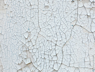 Old wall with white peeling paint. Grunge background
