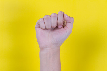 Close hand on yellow background