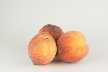 Three large ripe peaches