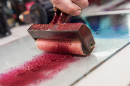 an acrylic paint roller for mono printing and screen printing, rolling paint ready for mono printing.