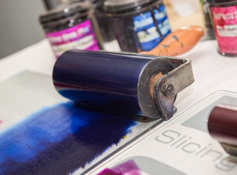 an acrylic paint roller for mono printing and screen printing, rolling paint ready for mono printing.