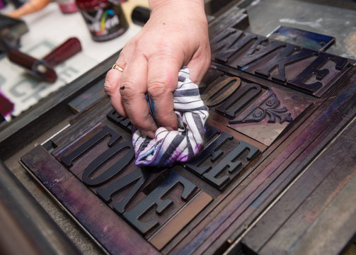 vintage  wooden antique analogue typeset letter blocks being prepared for block printing.