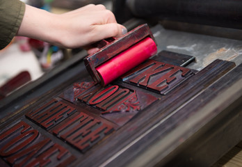 vintage  wooden antique analogue typeset letter blocks being prepared for block printing.