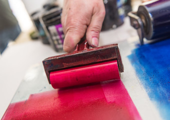 an acrylic paint roller for mono printing and screen printing, rolling paint ready for mono...