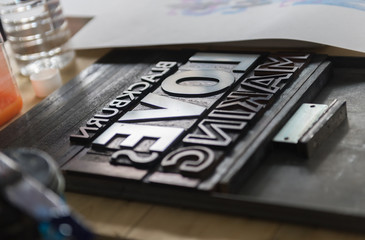 london, england, 05/05/2017 vintage wooden antique analogue typeset letter blocks being prepared for block printing.