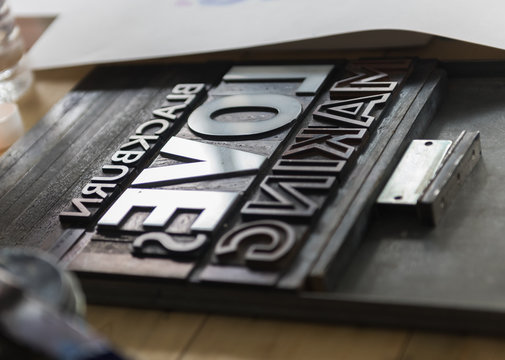 london, england, 05/05/2017 vintage wooden antique analogue typeset letter blocks being prepared for block printing.
