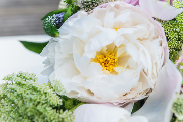 Bouquet of flowers from big peonies and pastel roses