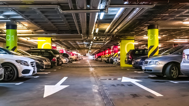 Modern, organized underground car parking garage. Perspective view. High-tech architecture