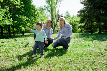 Fototapeta premium A family of four people are allowed to make soap bubbles.