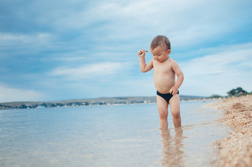 a small child standing in the sea