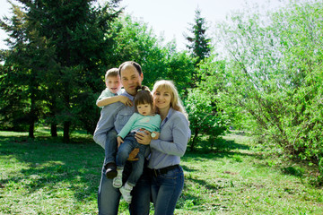 Fototapeta premium Portrait of a family of four outdoors.