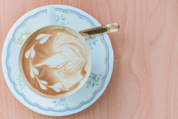 Coffee late art from top view on wood table,soft tone,time for coffee,relax