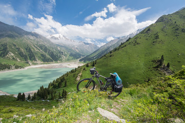 Fototapeta na wymiar Bicycle of a traveler, a mountain lake, Kazakhstan, Kyrgyzstan