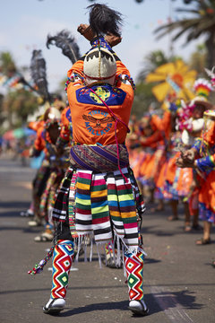 Tinkus dance group in colourful costumes performing a traditional ritual dance as part of the Carnaval Andino con la Fuerza del Sol in Arica, Chile.